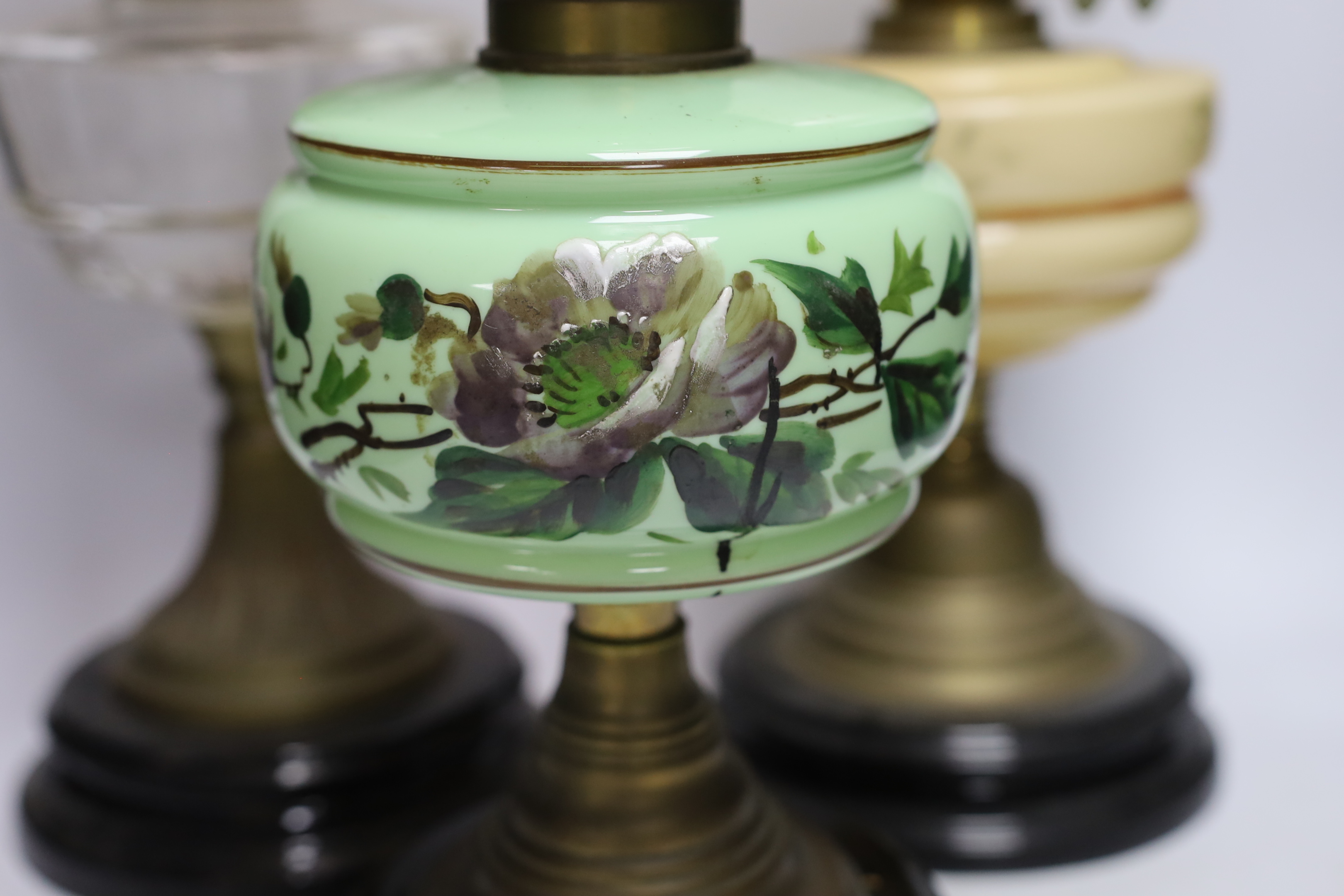 Three glass and brass oil lamps, c.1900, tallest 57cm